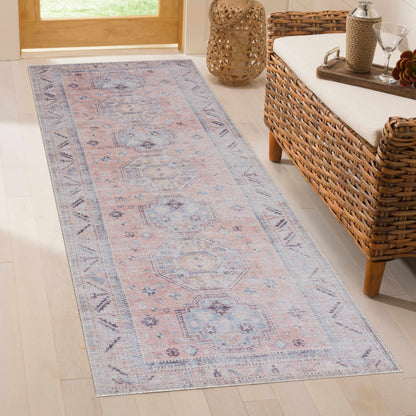 Morcott Peach Washable Area Rug by Boutique Rugs in peach and blue geometric pattern on Tampa Home & Garden Store
