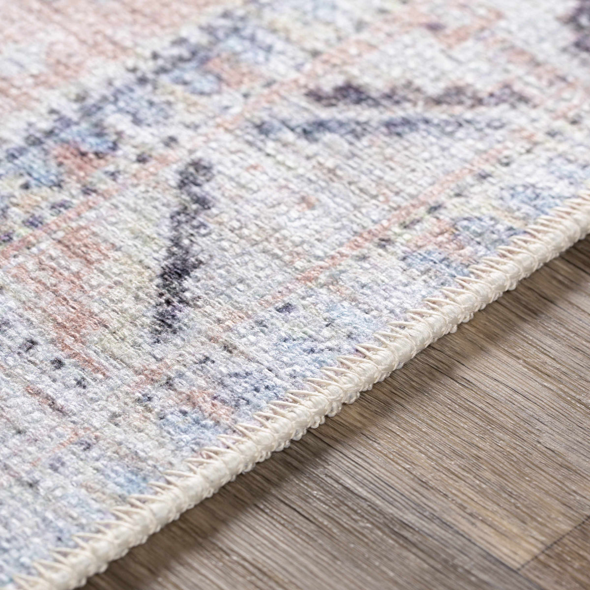 Morcott Peach Washable Area Rug by Boutique Rugs, multicolor fringe on wood floor on Tampa Home & Garden Store