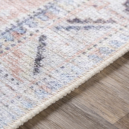 Morcott Peach Washable Area Rug by Boutique Rugs, multicolor fringe on wood floor on Tampa Home & Garden Store