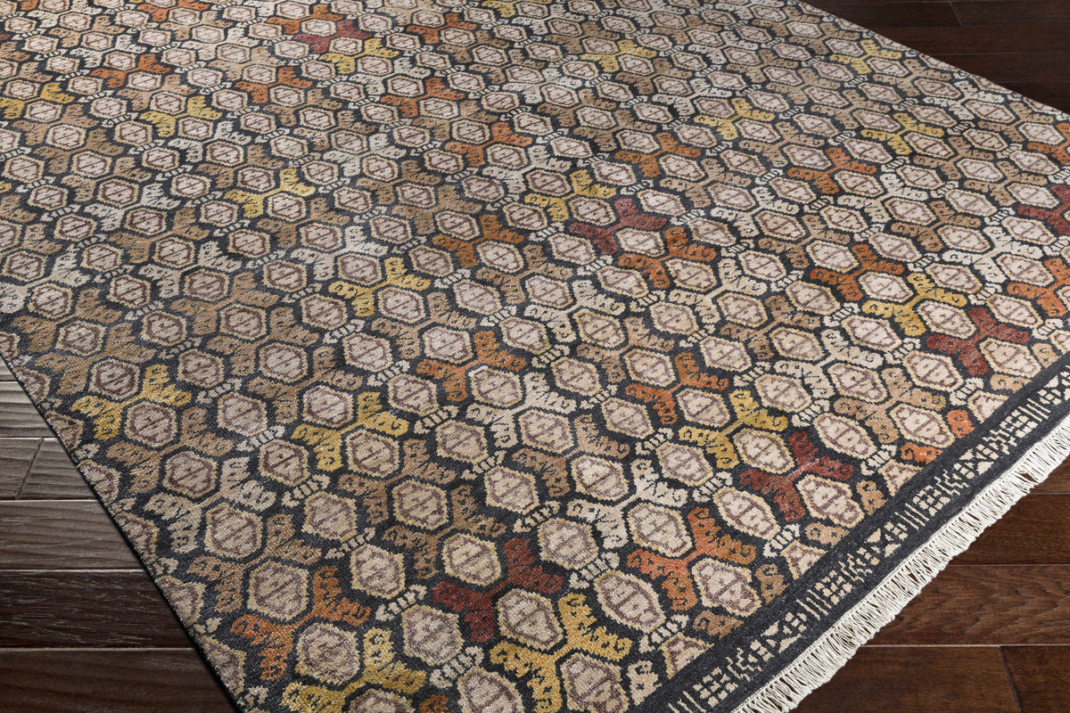 Mercersburg Carpet rug by Boutique Rugs with warm hexagon pattern on dark base and fringe on Tampa Home & Garden Store