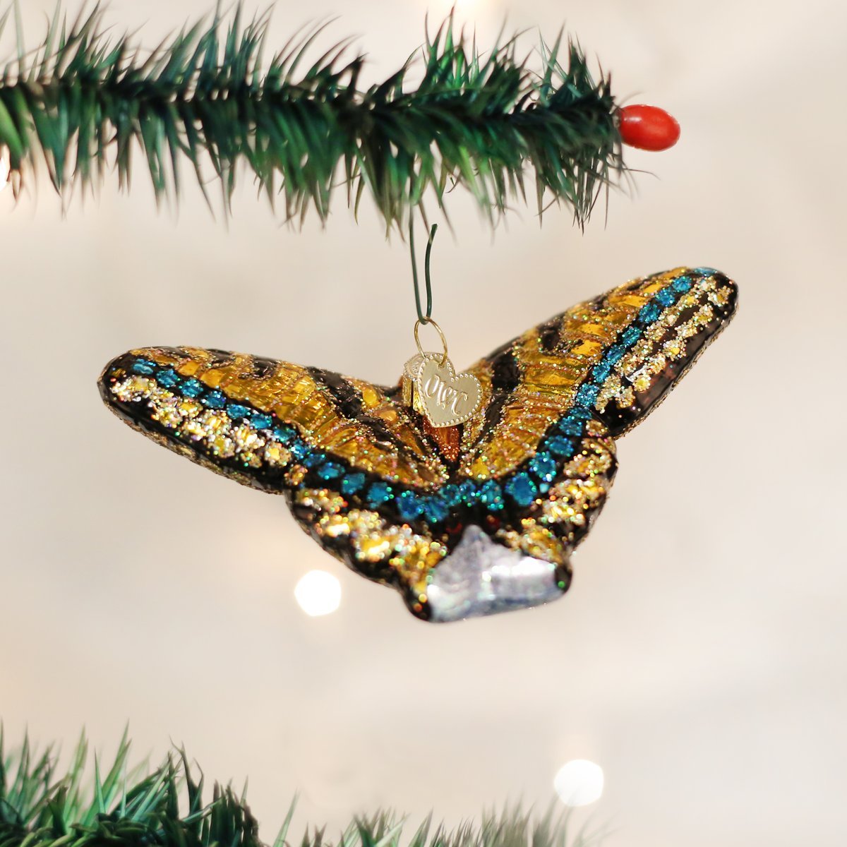 Swallowtail Butterfly Glass Ornament with gold, teal and blue glitter wings on a Christmas tree on Tampa Home & Garden Store