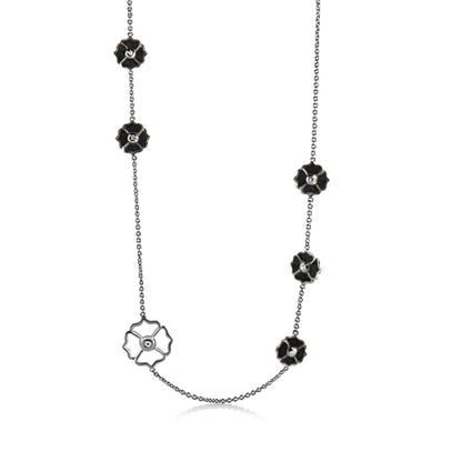 Poppy Love Long Necklace with black flower charms on a silver chain and a white floral pendant on Tampa Home & Garden Store