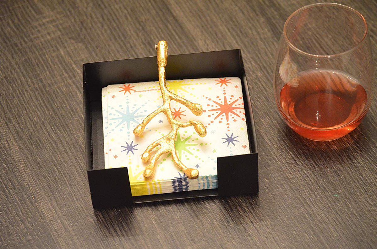 Vibhsa napkin holder with gold olive bud, colorful starburst napkin in display box on Tampa Home & Garden Store