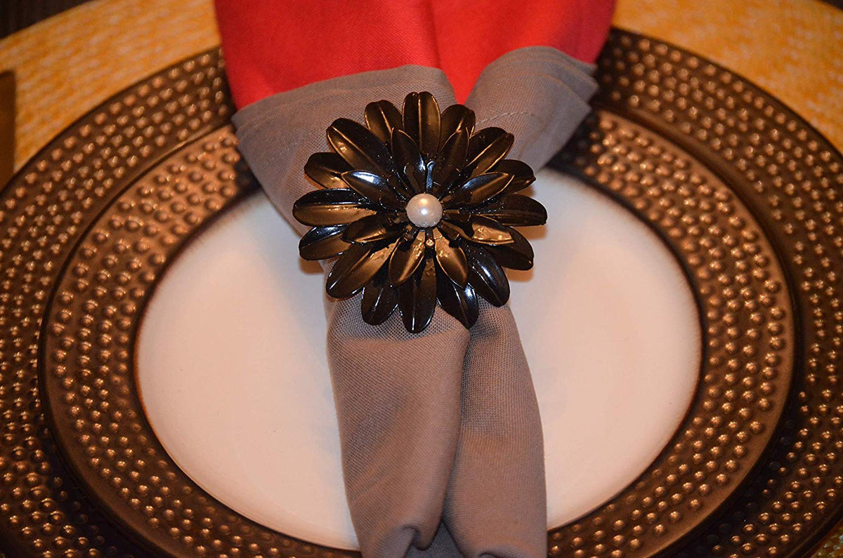 Vibhsa black floral napkin ring with pearl accents on gray napkin, set of 4, handcrafted on Tampa Home & Garden Store