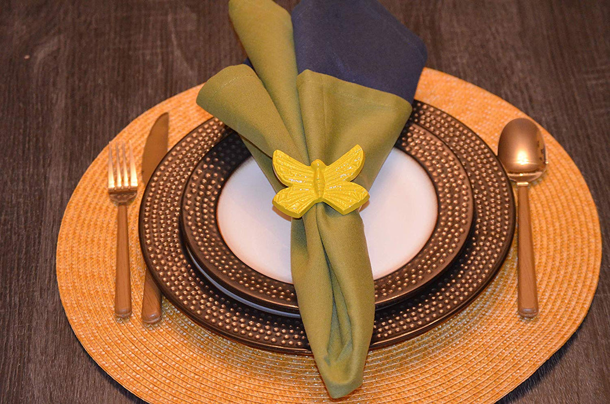 Vibhsa yellow butterfly napkin ring on olive green folded napkin with brown beaded charger plate on Tampa Home & Garden Store