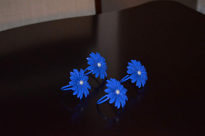 Vibhsa blue floral napkin rings set of 4 with pearl centers handcrafted on a dark table on Tampa Home & Garden Store