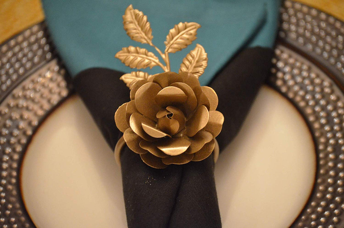 Vibhsa gold rose napkin ring on a black napkin with gold leaf accents on beaded plate on Tampa Home & Garden Store