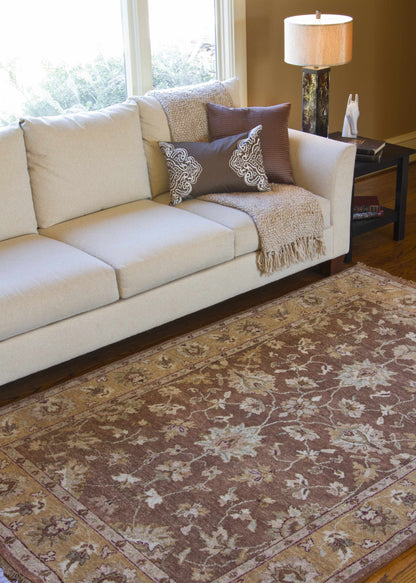 Napolville Premium Wool Area Rug by Boutique Rugs; brown rug with ivory border under beige sofa on Tampa Home & Garden Store