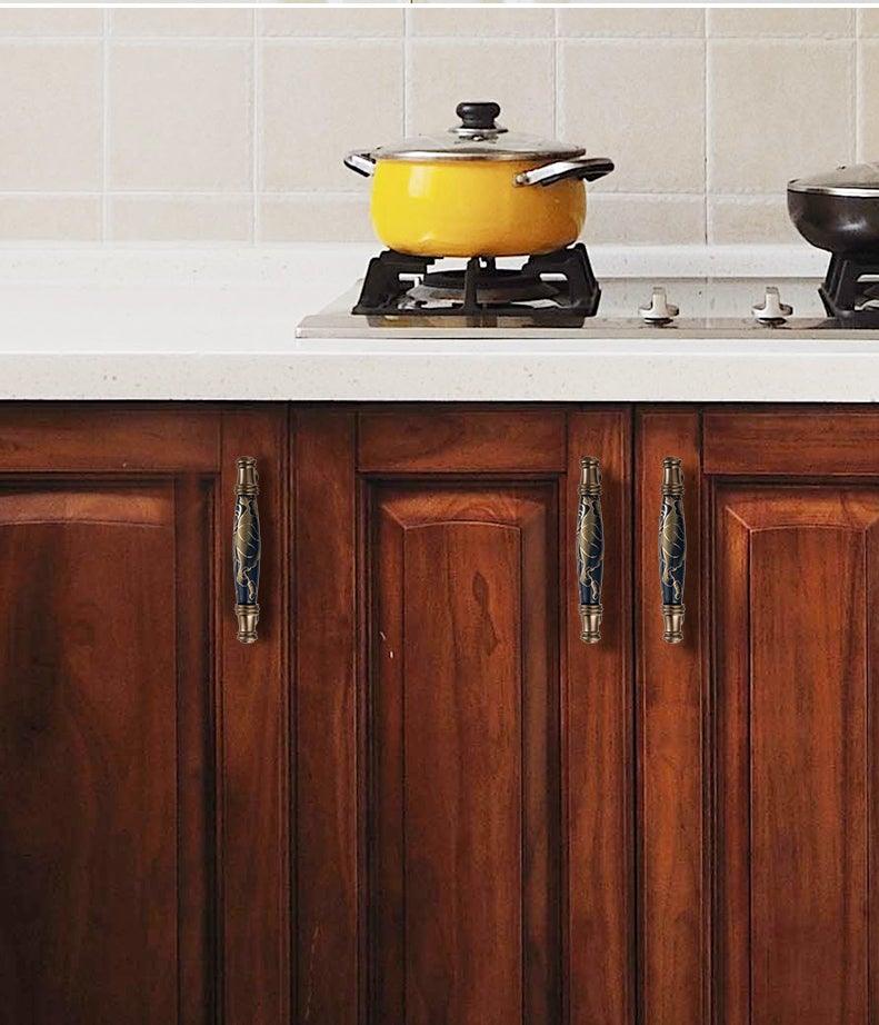 Navy blue ceramic cabinet door handle pull with ornate metal ends by Stevvex on wood cabinets on Tampa Home & Garden Store