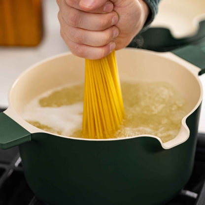 5-Piece Stackable Ceramic Nonstick Cookware Set green exterior cream interior in use boiling pasta on Tampa Home & Garden Store