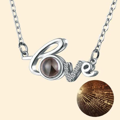 Silver-tone Love pendant necklace with a dark pearl O and diamonds on a chain on Tampa Home & Garden Store