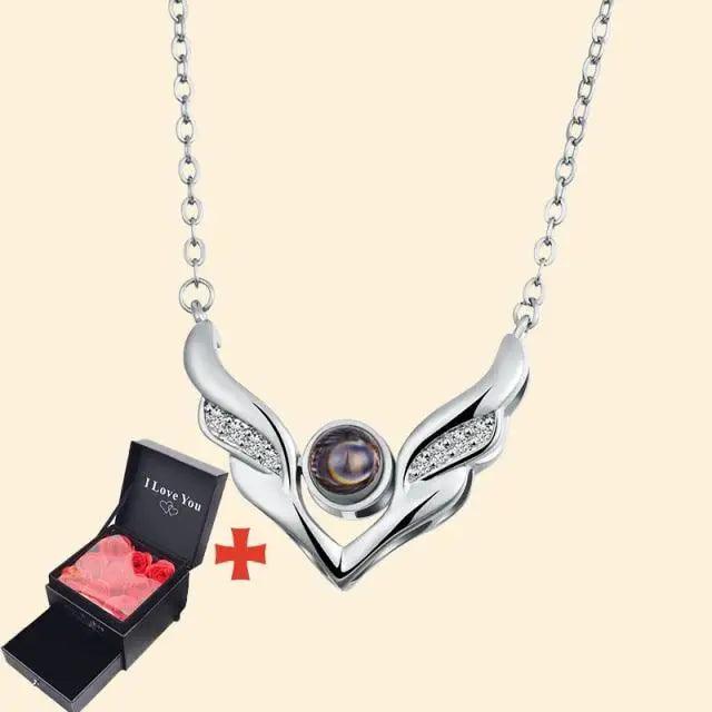 Stevvex wing pendant necklace with purple center gem on silver chain beside black gift box on Tampa Home & Garden Store