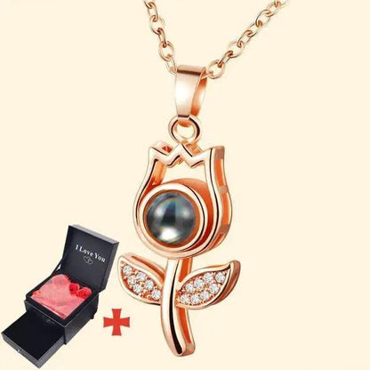 Rose-gold owl pendant necklace with blue cabochon gem on chain; gift box with pink roses on Tampa Home & Garden Store