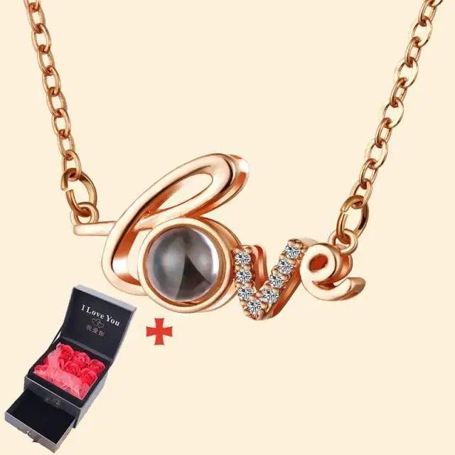 Rose-gold Love pendant necklace with crystal-studded V and round O charm, next to black gift box on Tampa Home & Garden Store