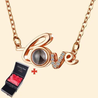 Rose-gold Love pendant necklace with crystal-studded V and round O charm, next to black gift box on Tampa Home & Garden Store