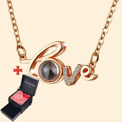Rose gold love pendant necklace with rhinestone accents, with a black gift box and pink hearts on Tampa Home & Garden Store