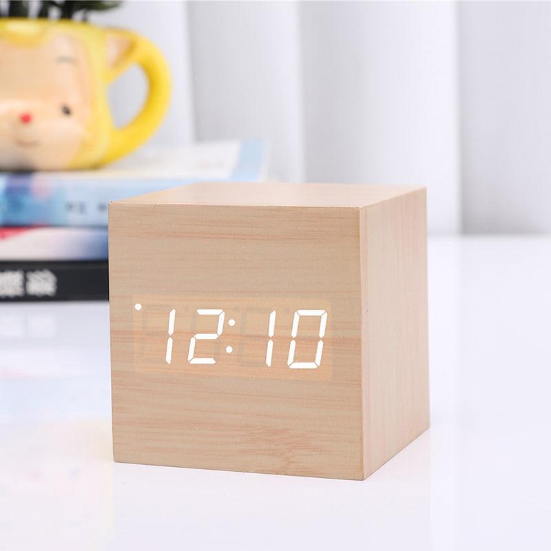 Wooden cube LED alarm clock by Stevvex, displays 12:10 on a desk on Tampa Home & Garden Store