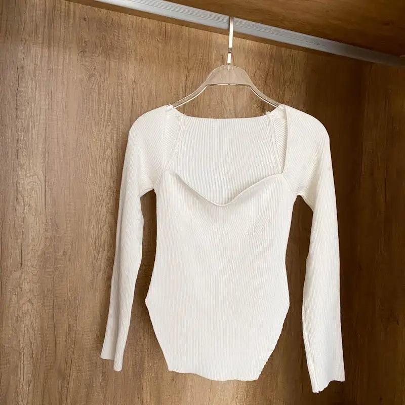White ribbed knit long-sleeve sweater with curved neckline on hanger on Tampa Home & Garden Store