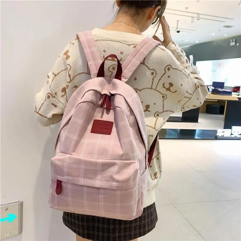 Stevvex pink plaid school backpack with front pocket and red zipper pulls on Tampa Home & Garden Store