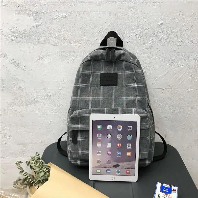 Stevvex striped gray plaid school backpack with front pocket, top handle, tablet for scale on Tampa Home & Garden Store