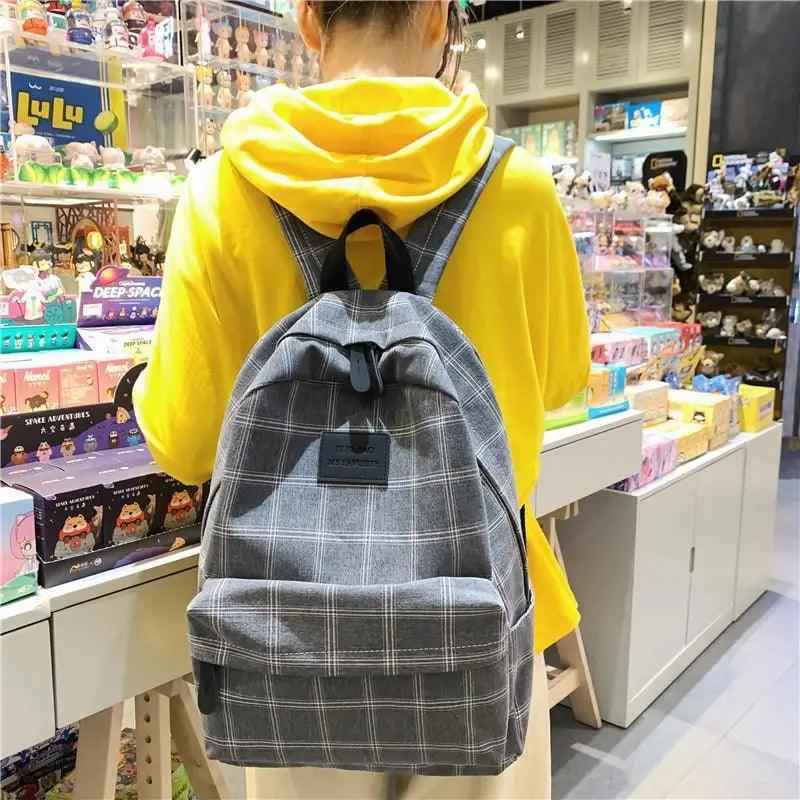 Stevvex gray plaid school backpack with front pocket and black straps on Tampa Home & Garden Store