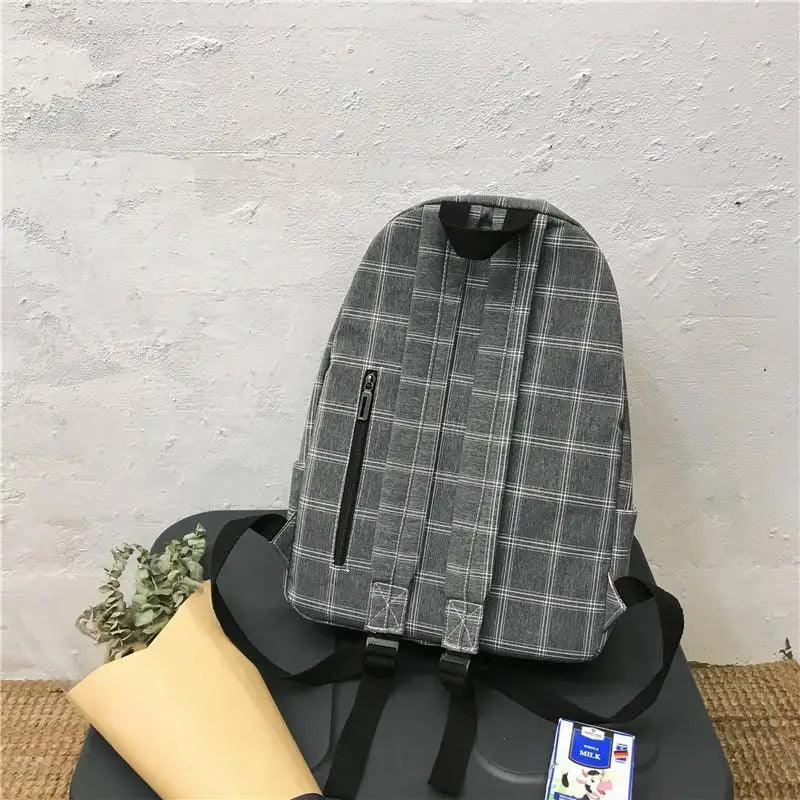 Grey plaid school backpack with front zip pocket and adjustable straps on Tampa Home & Garden Store