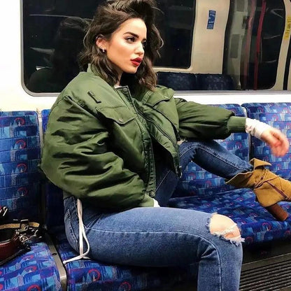 Stevvex green bomber jacket worn by a woman on subway; short padded outerwear, long sleeves on Tampa Home & Garden Store