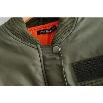 Green women's bomber jacket with orange lining, ribbed collar and zip front on Tampa Home & Garden Store