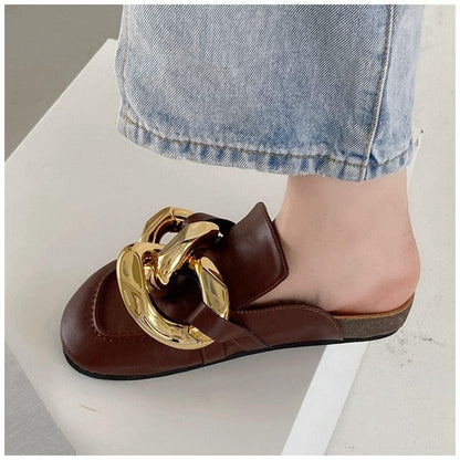 Brown leather slide mule with oversized gold chain ornament, closed toe, low heel on Tampa Home & Garden Store