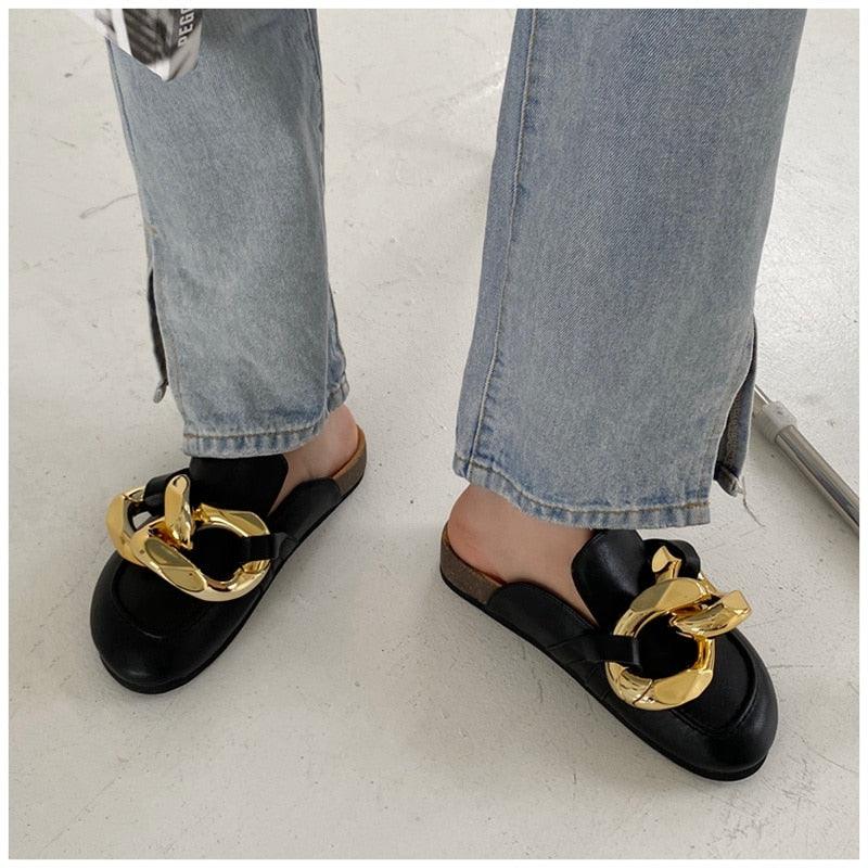 Pair of Stevvex black slip-on sandals with large gold chain detail on Tampa Home & Garden Store