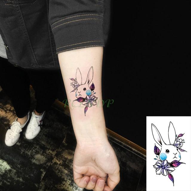 Temporary tattoo of a cute rabbit with colorful flowers on forearm on Tampa Home & Garden Store