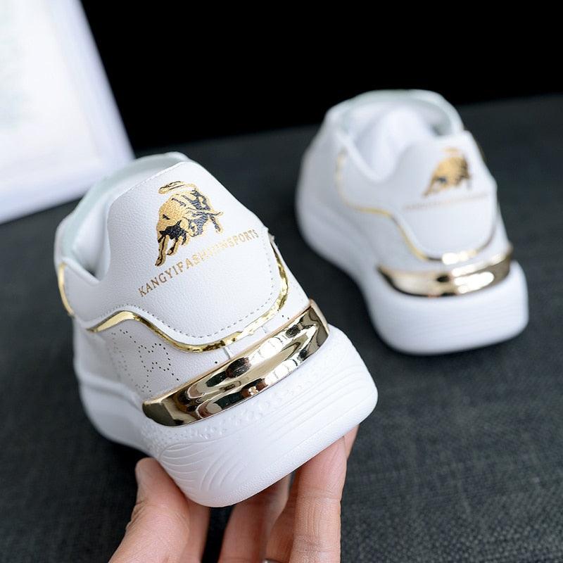 Stevvex white sneakers with thick sole and gold metallic heel accent, two sneakers shown on Tampa Home & Garden Store
