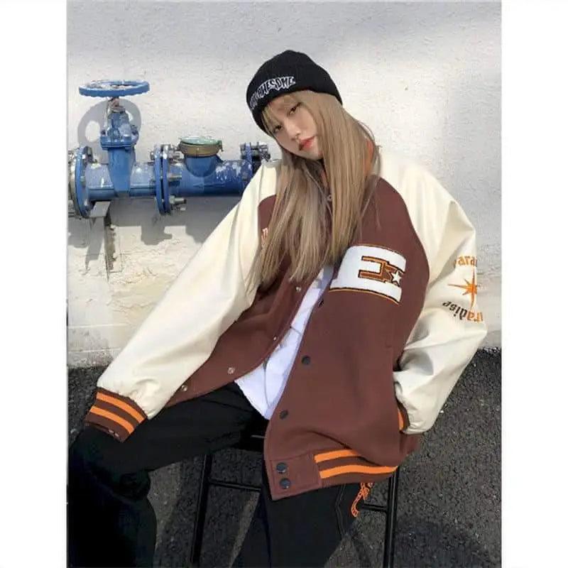 Stevvex varsity jacket brown body, cream sleeves, bone patch on chest, orange-striped cuffs on Tampa Home & Garden Store