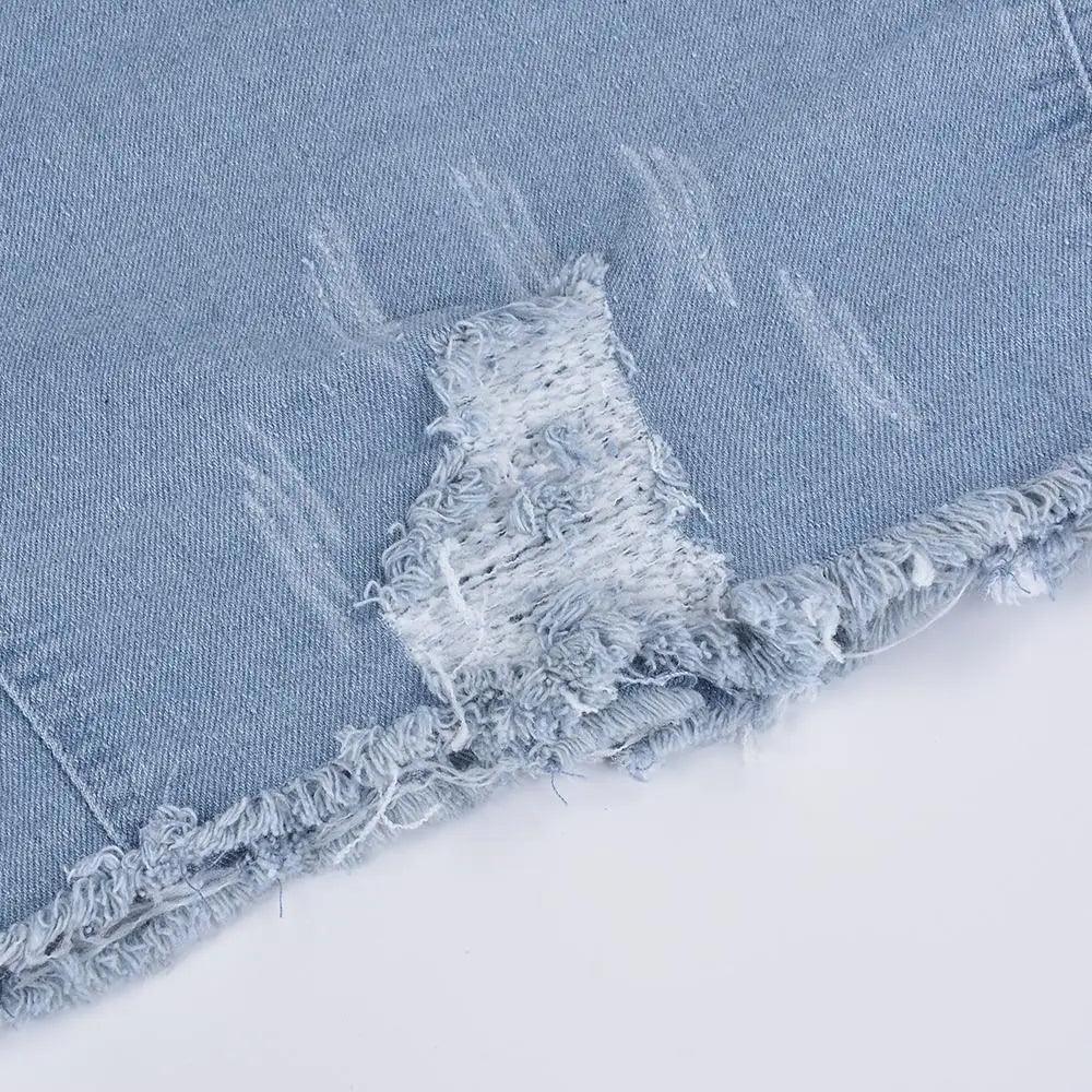 Ripped light-wash denim jacket hem detail with frayed edge trucker style on Tampa Home and Garden Store