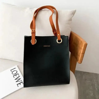 Stevvex leather shoulder bag black body with tan straps and gold rings AIBEIDA logo visible on Tampa Home & Garden Store