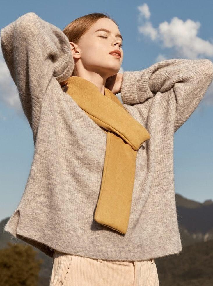 Stevvex heated scarf neck warmer in tan worn with beige knit sweater outdoors on Tampa Home & Garden Store