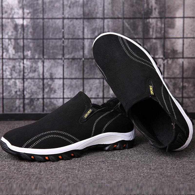 Stevvex men's black casual sport sneakers, with white sole and orange traction pods on Tampa Home & Garden Store
