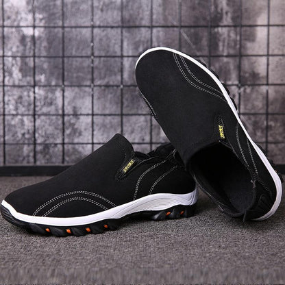 Stevvex men's black casual sport sneakers, with white sole and orange traction pods on Tampa Home & Garden Store