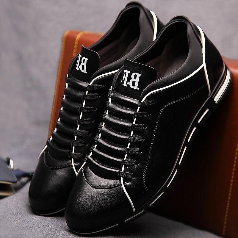 Pair of Stevvex black leather sneakers with white piping and chunky sole on Tampa Home & Garden Store