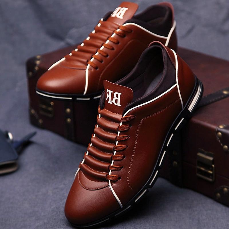 Pair of men's brown leather casual sneakers with white piping and lace-up front on Tampa Home & Garden Store