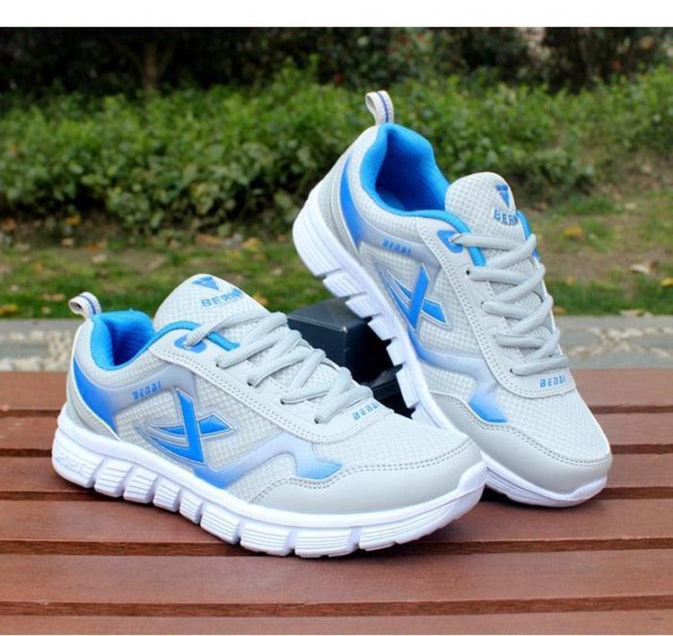 Men's white and blue sport sneakers with breathable mesh upper and cushioned sole, pair on Tampa Home & Garden Store
