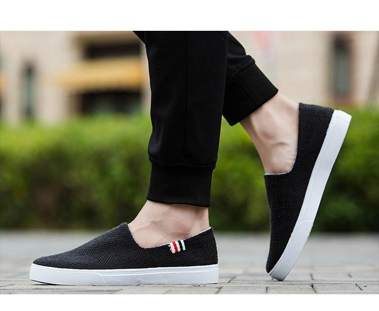 Stevvex black canvas slip-on sneakers with white sole and striped side tab on Tampa Home & Garden Store