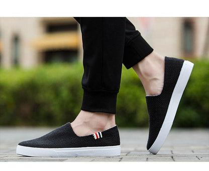Stevvex black canvas slip-on sneakers with white sole and striped side tab on Tampa Home & Garden Store