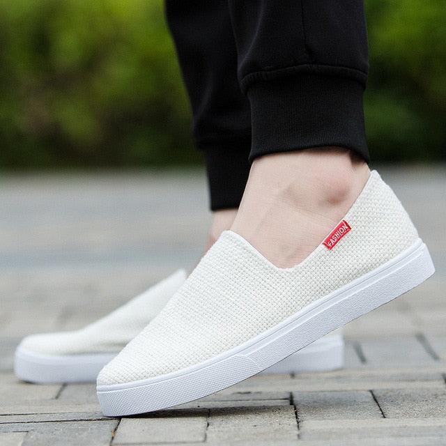 Stevvex white canvas slip-on sneakers, lightweight casual flat walking shoes with red tag on Tampa Home & Garden Store