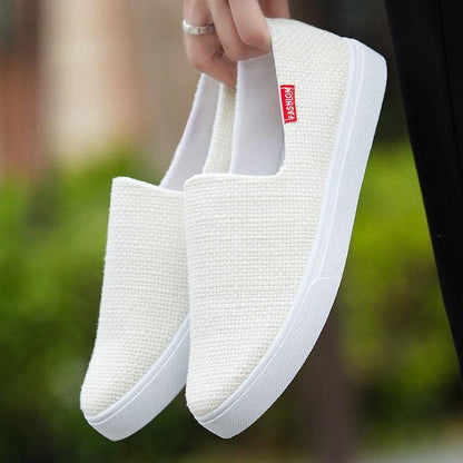 Pair of white canvas slip-on sneakers with textured knit and white rubber sole on Tampa Home & Garden Store