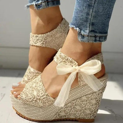 Beige lace wedge sandals with ankle strap and bow, espadrille-style jute sole on Tampa Home & Garden Store
