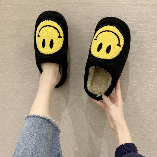 Smiley-face plush slippers, black with yellow emoji, fluffy interior, slip-on home footwear on Tampa Home & Garden Store