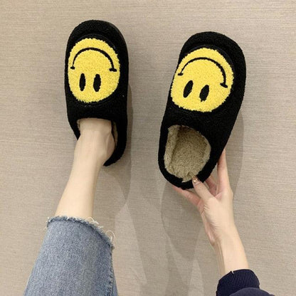 Smiley-face plush slippers, black with yellow emoji, fluffy interior, slip-on home footwear on Tampa Home & Garden Store