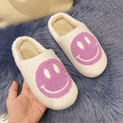 Stevvex pink smiley face plush slippers, white fluffy slip-ons with purple smiley, indoor pair on Tampa Home & Garden Store
