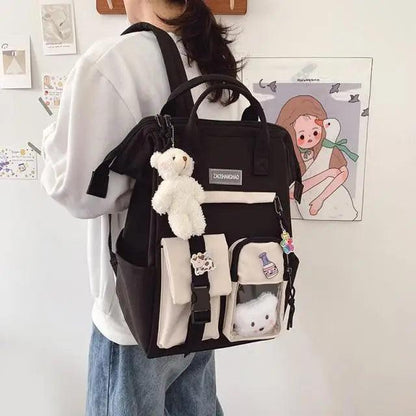 Stevvex black school backpack with beige front pockets and plush teddy bear keychain on Tampa Home & Garden Store